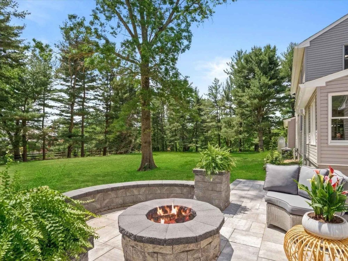 backyard patio with stone firepit and outdoor seating in a houghton contracting custom home project in trenton new jersey