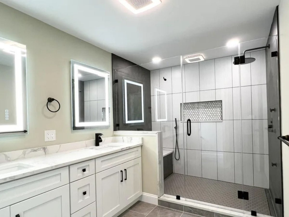 primary bathroom with glass shower and dark tile accent wall in a houghton contracting custom home project in trenton new jersey