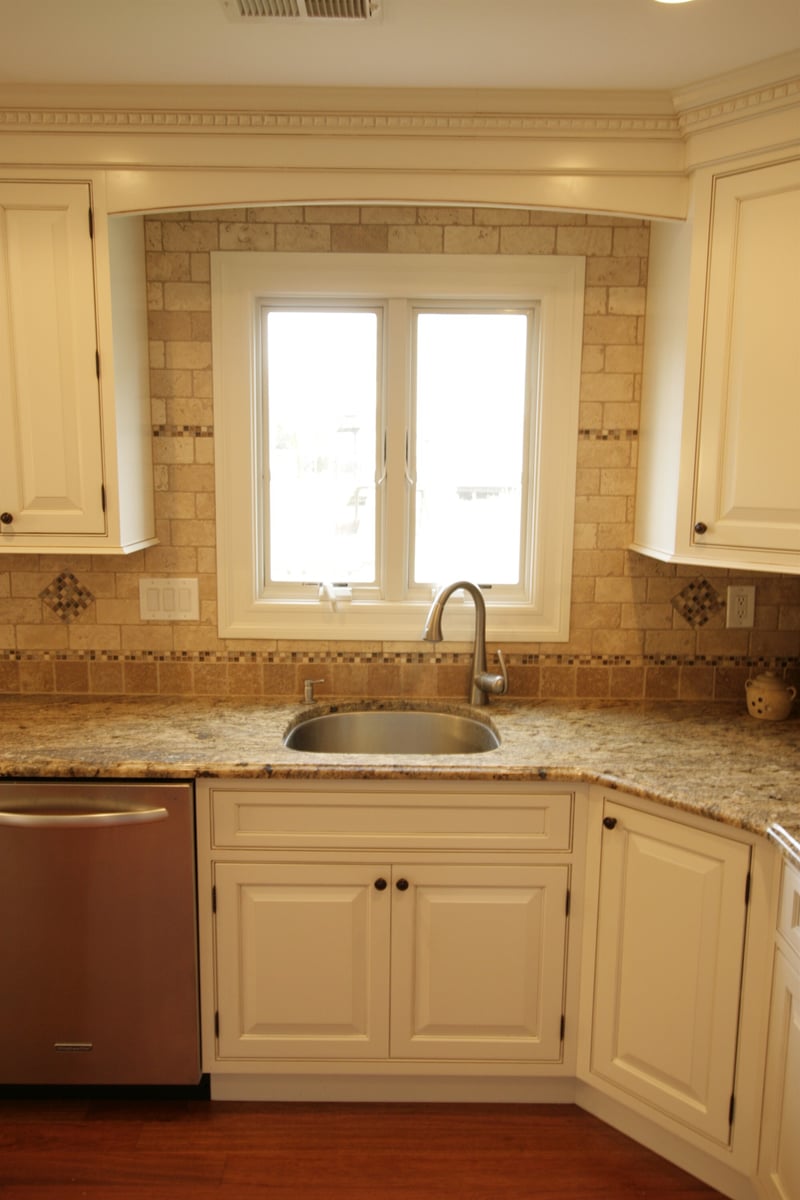 kitchen basin under window with travertine and mosaic backsplash custom home project by houghton contracting in newtown pa-optimized