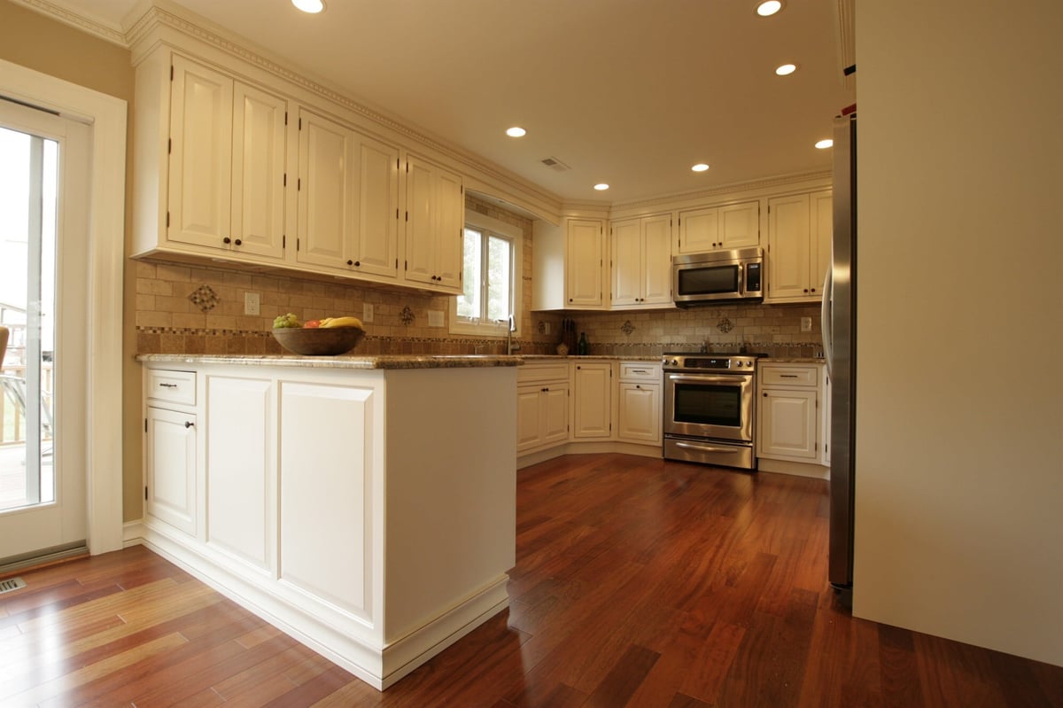 kitchen peninsula and stainless gas range with tile backsplash custom home project by houghton contracting in newtown pa-optimized