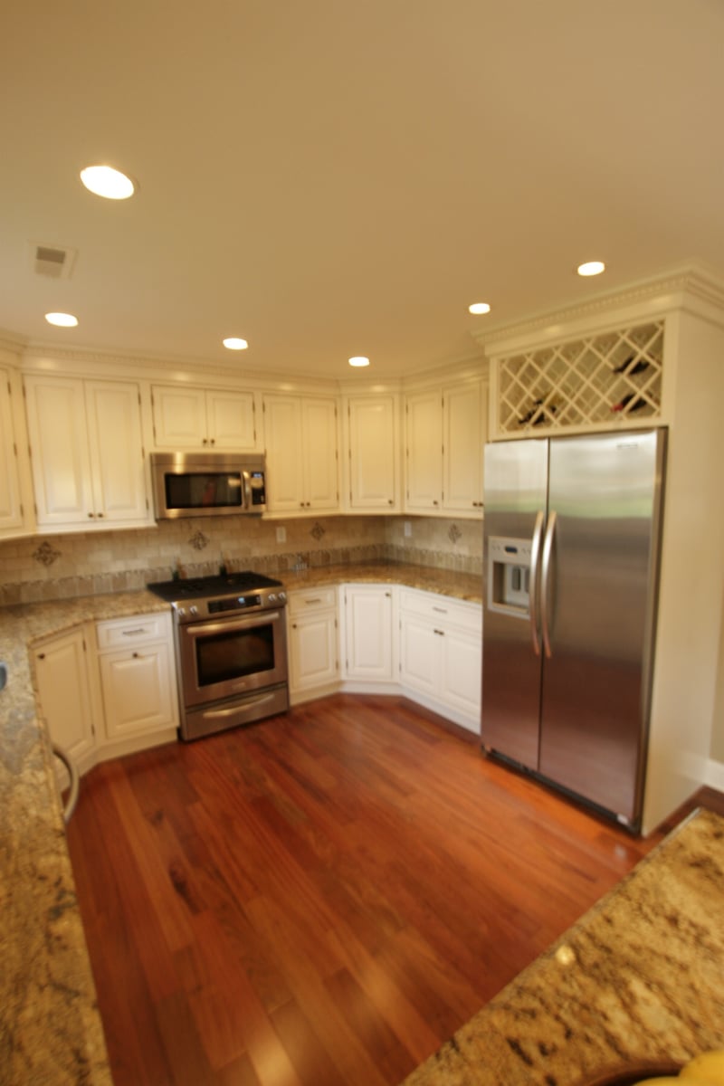white kitchen with stainless refrigerator and wine rack cabinet custom home project by houghton contracting in newtown pa-optimized