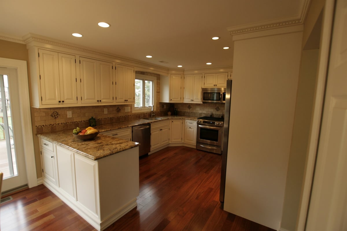 wide view of white kitchen with peninsula and stainless appliances custom home project by houghton contracting in newtown pa-optimized