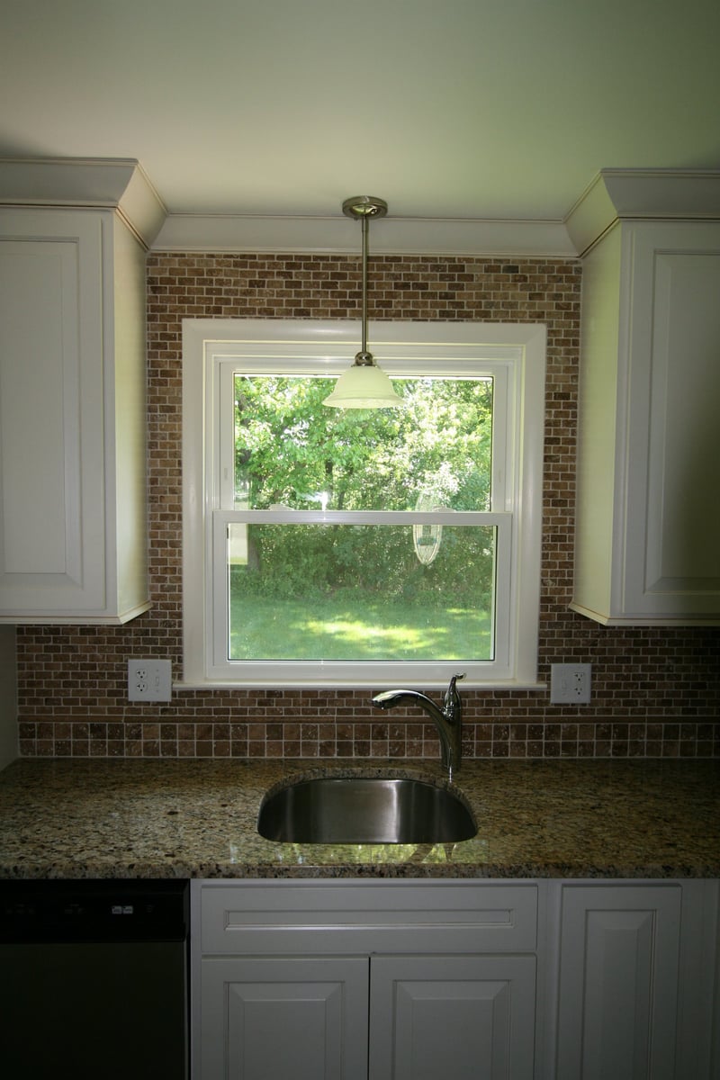kitchen bar sink beneath double hung window with brick tile backsplash custom home project by houghton contracting in ewing new jersey - optimized