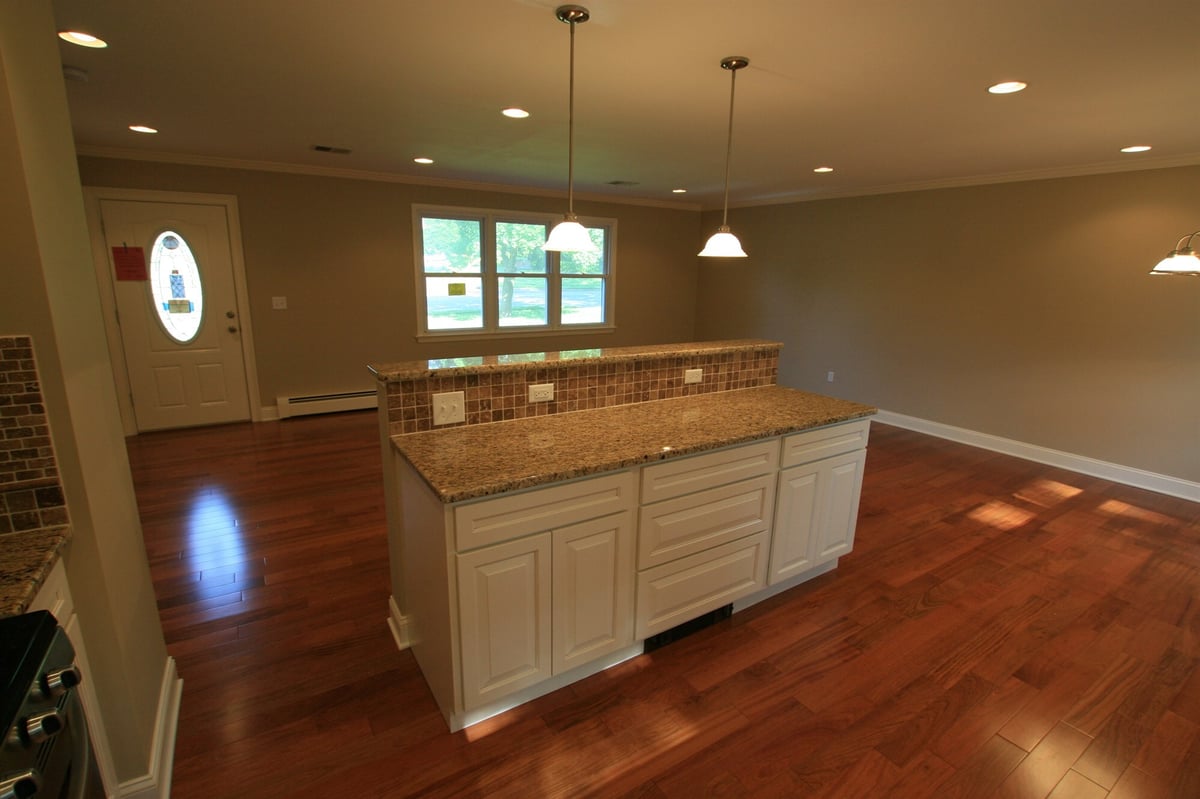 kitchen peninsula with granite counter and view to front door custom home project by houghton contracting in ewing new jersey
