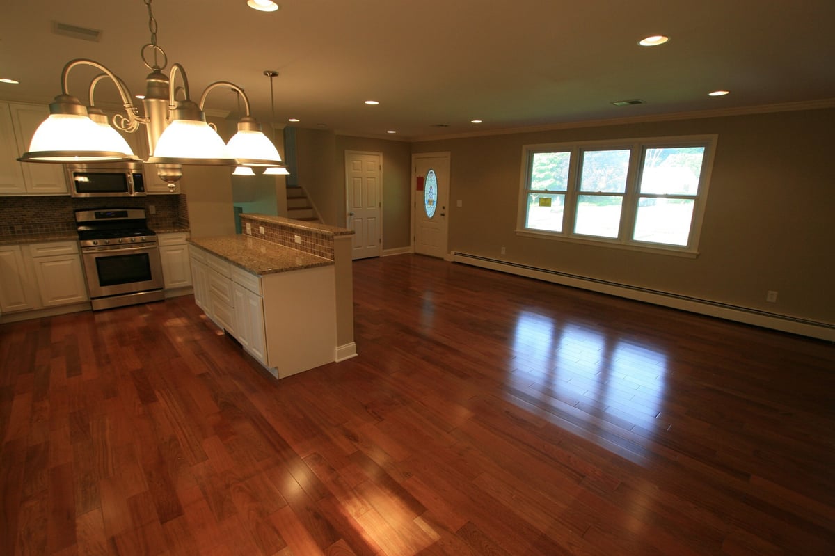 open living space with hardwood floors and stainless kitchen appliances custom home project by houghton contracting in ewing new jersey