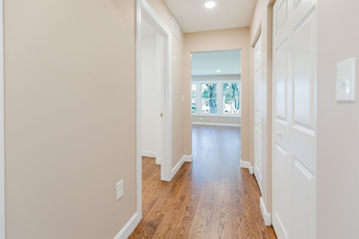 hallway leading to sunroom addition with oak floors home addition project by houghton contracting in lawrenceville new jersey-optimized