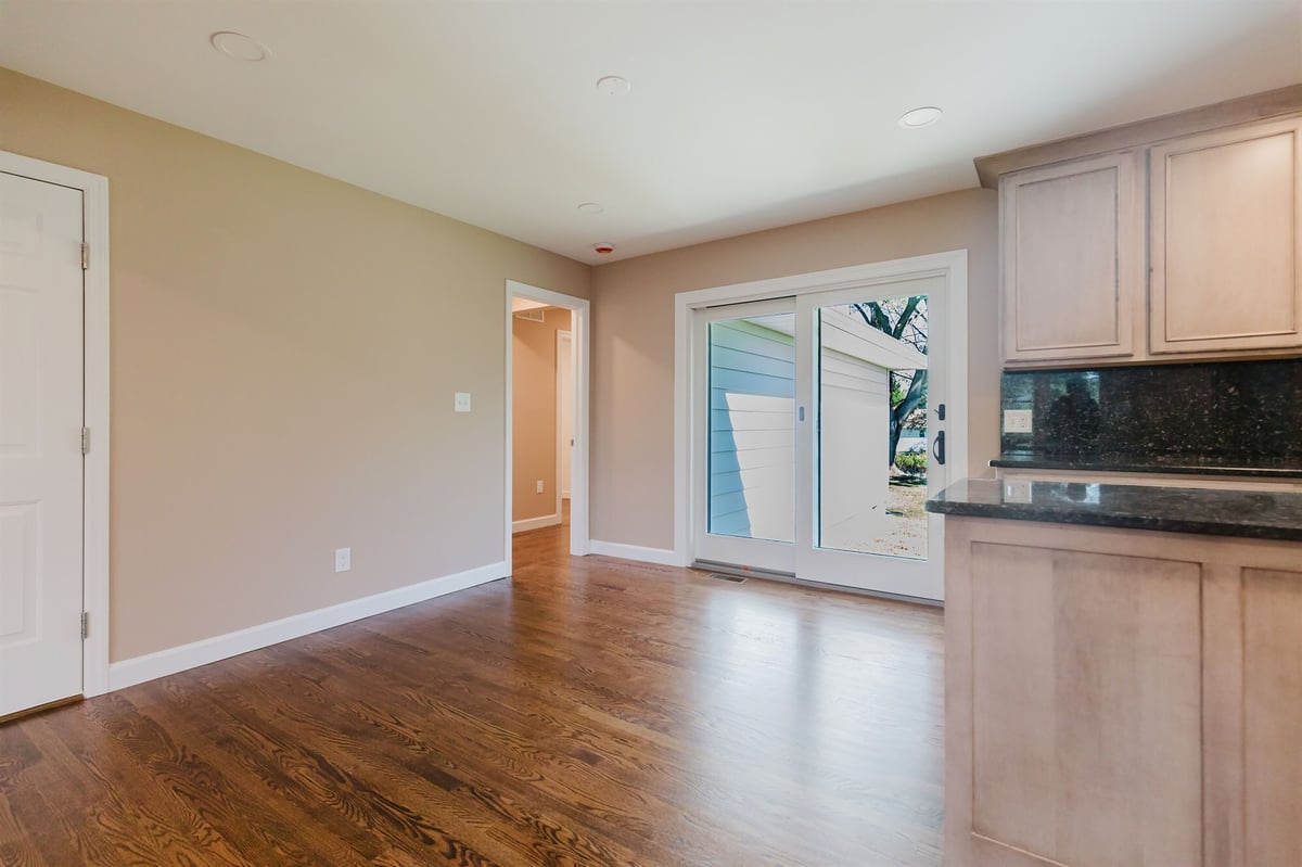 kitchen dining area with granite peninsula and sliding patio door home addition project by houghton contracting in lawrenceville new jersey- - Copy