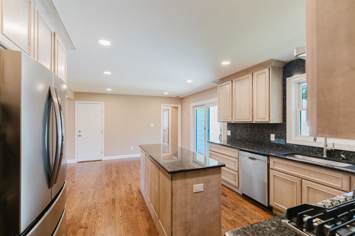 kitchen island and stainless refrigerator with patio door home addition project by houghton contracting in lawrenceville new jersey-optimize - Copy