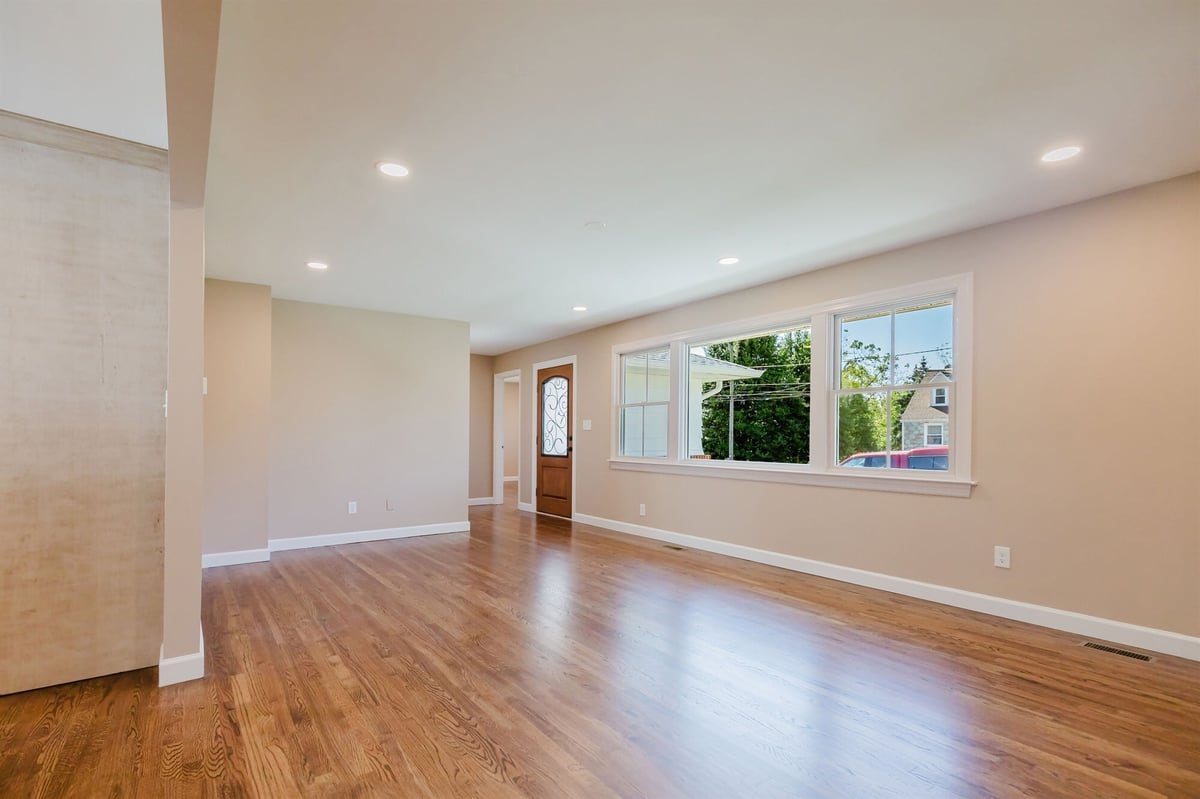 living room with iron glass front door and picture window home addition project by houghton contracting in lawrenceville new jersey-optimized