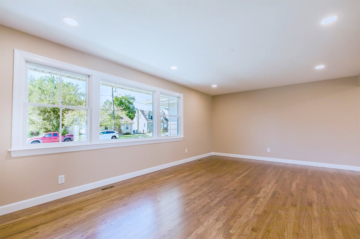 living room with triple picture window and recessed lighting home addition project by houghton contracting in lawrenceville new jersey-optimized
