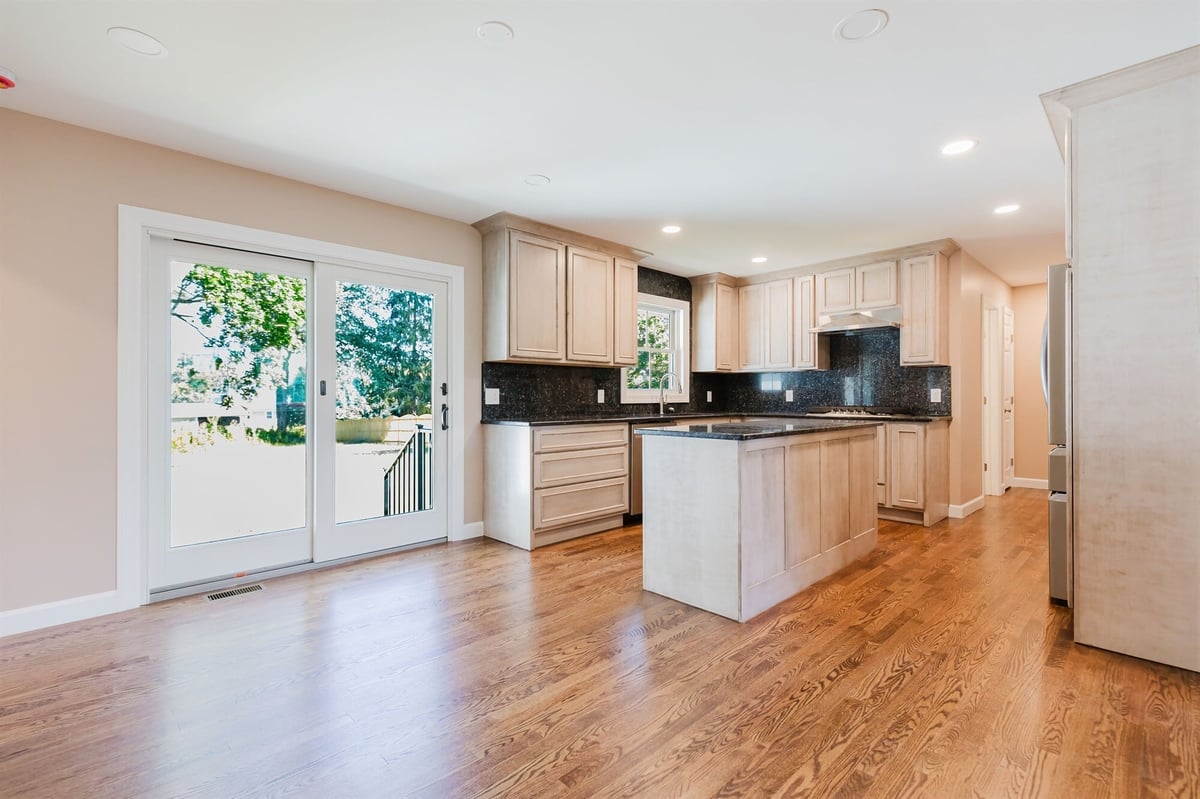 maple kitchen with black granite counters island and patio door home addition project by houghton contracting in lawrenceville new jersey-optimized