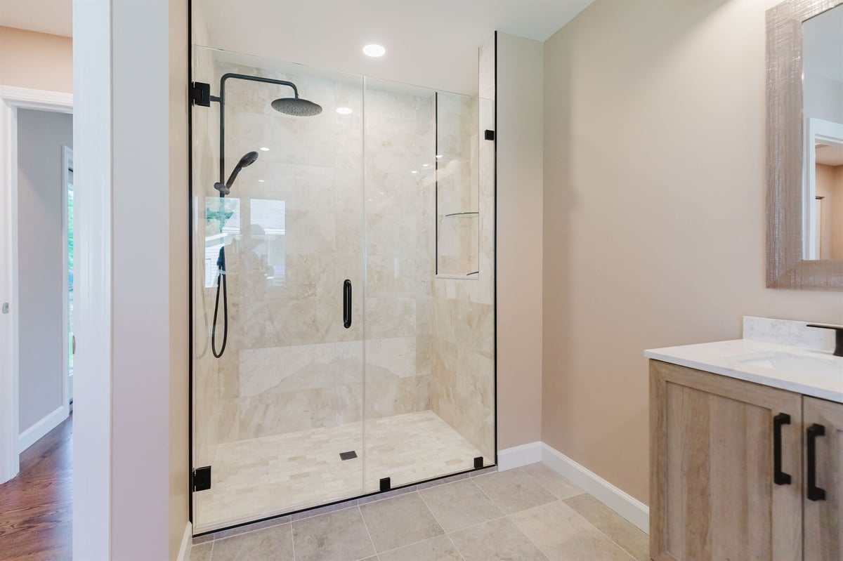 marble tile walk in shower with rainfall head and wood vanity home addition project by houghton contracting in lawrenceville new jersey-optimized