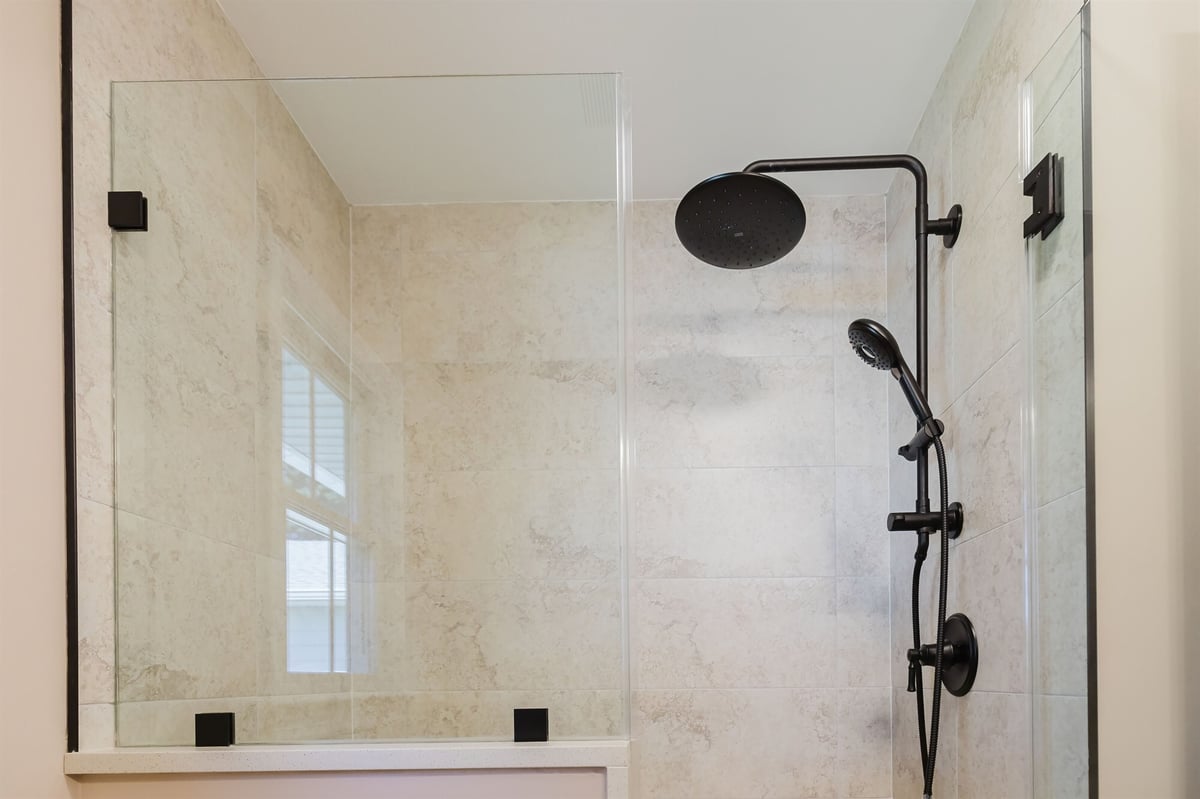 walk in shower with black fixtures and glass half wall home addition project by houghton contracting in lawrenceville new jersey-optimized