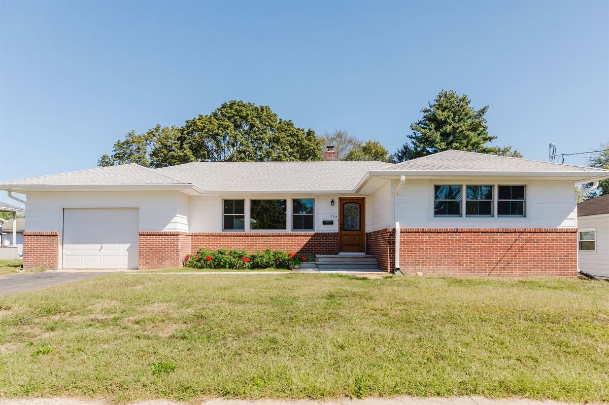 white ranch home exterior with brick facade and attached garage home addition project by houghton contracting in lawrenceville new jersey-optimized