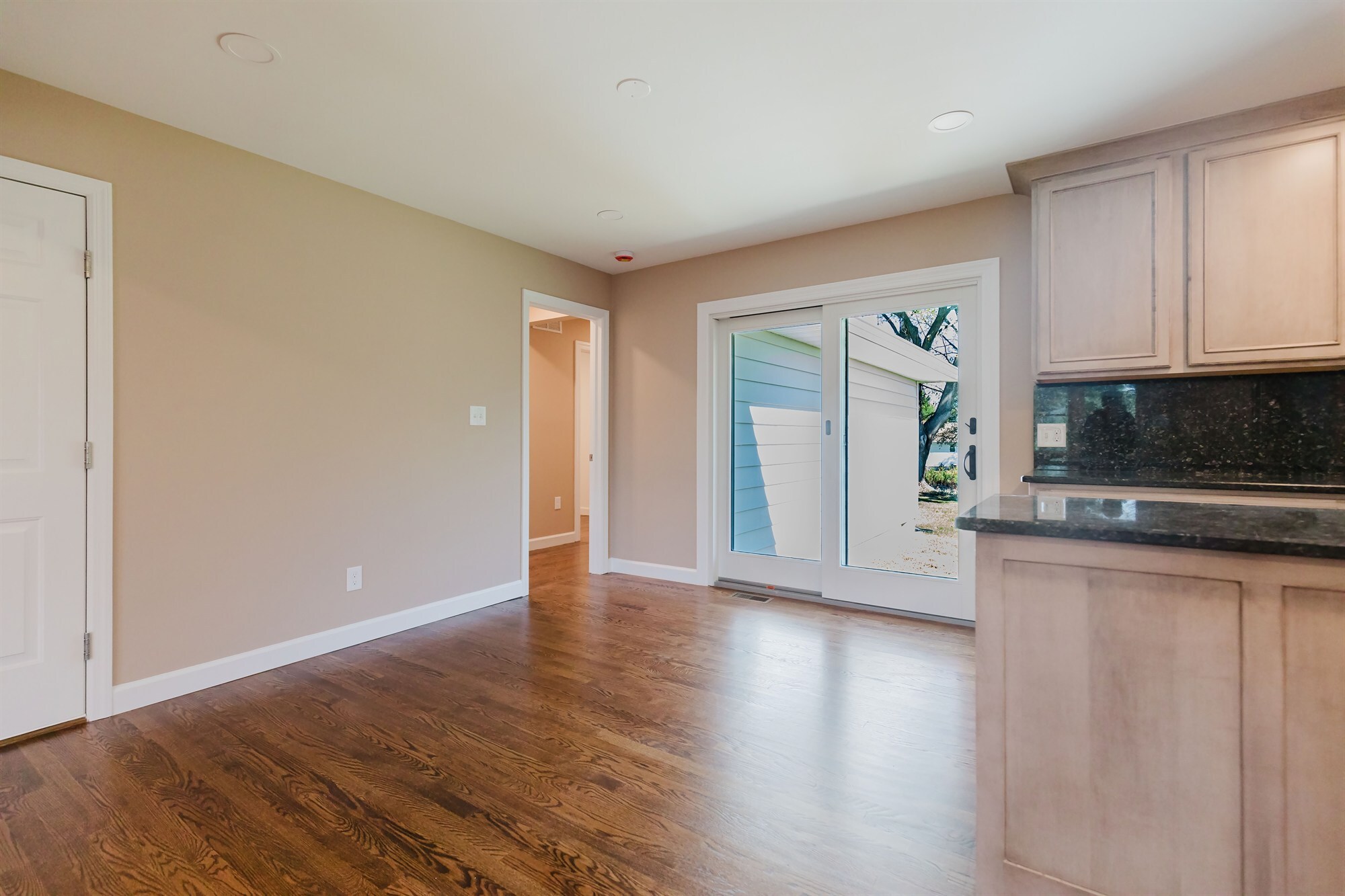 kitchen dining area with granite peninsula and sliding patio door home addition project by houghton contracting in lawrenceville new jersey-optimized