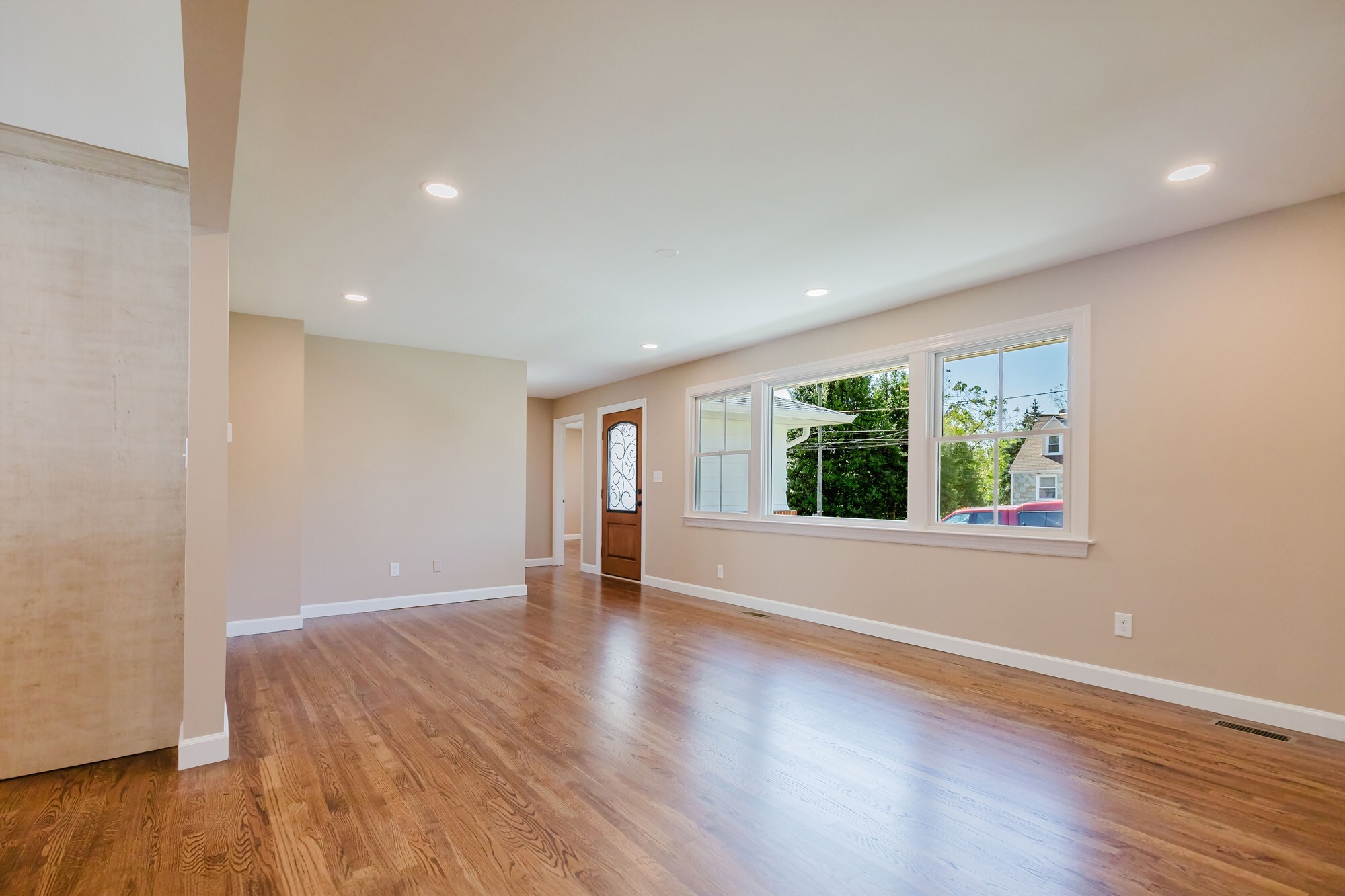 living room with iron glass front door and picture window home addition project by houghton contracting in lawrenceville new jersey-optimized