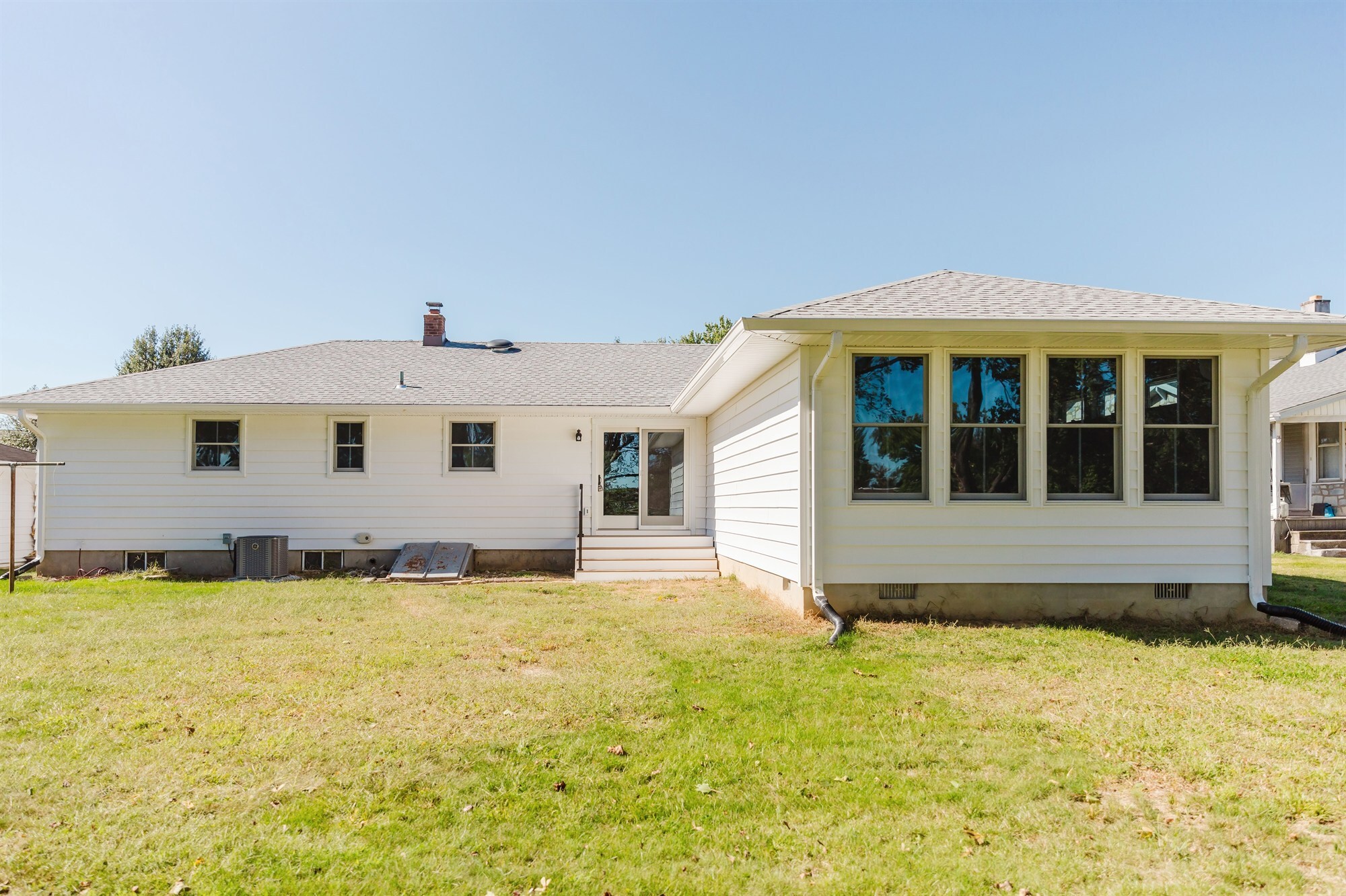 rear exterior with new sunroom addition and bank of windows home addition project by houghton contracting in lawrenceville new jersey-optimized