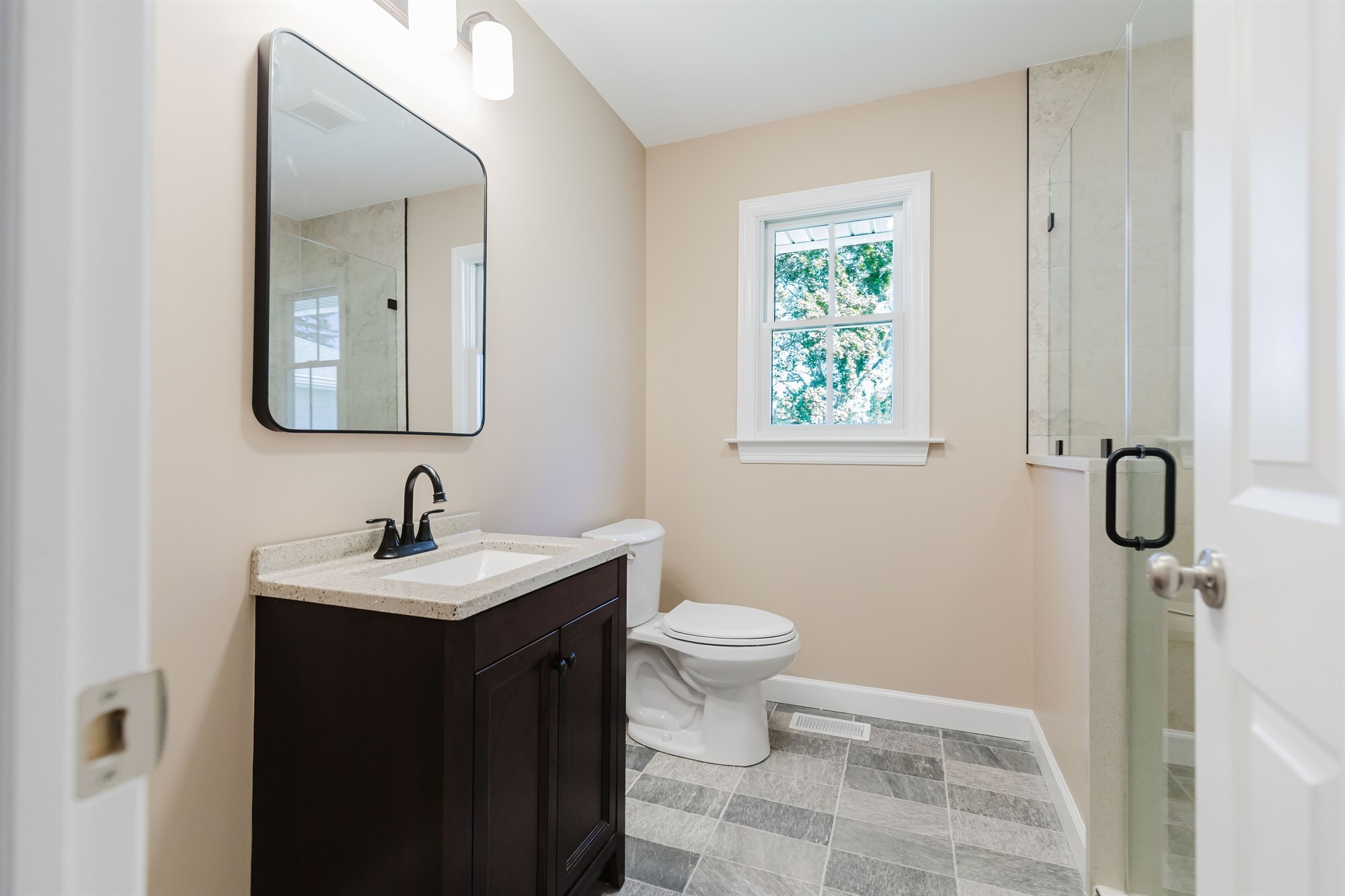 second bathroom with dark vanity and glass shower home addition project by houghton contracting in lawrenceville new jersey-optimized