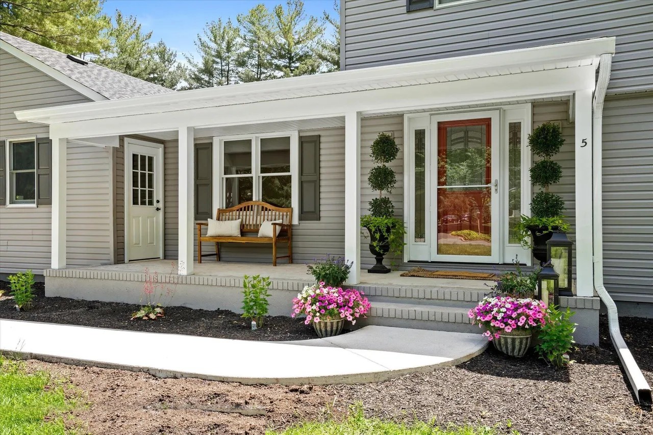 covered front porch entryway with red door in a houghton contracting custom home project in trenton new jersey