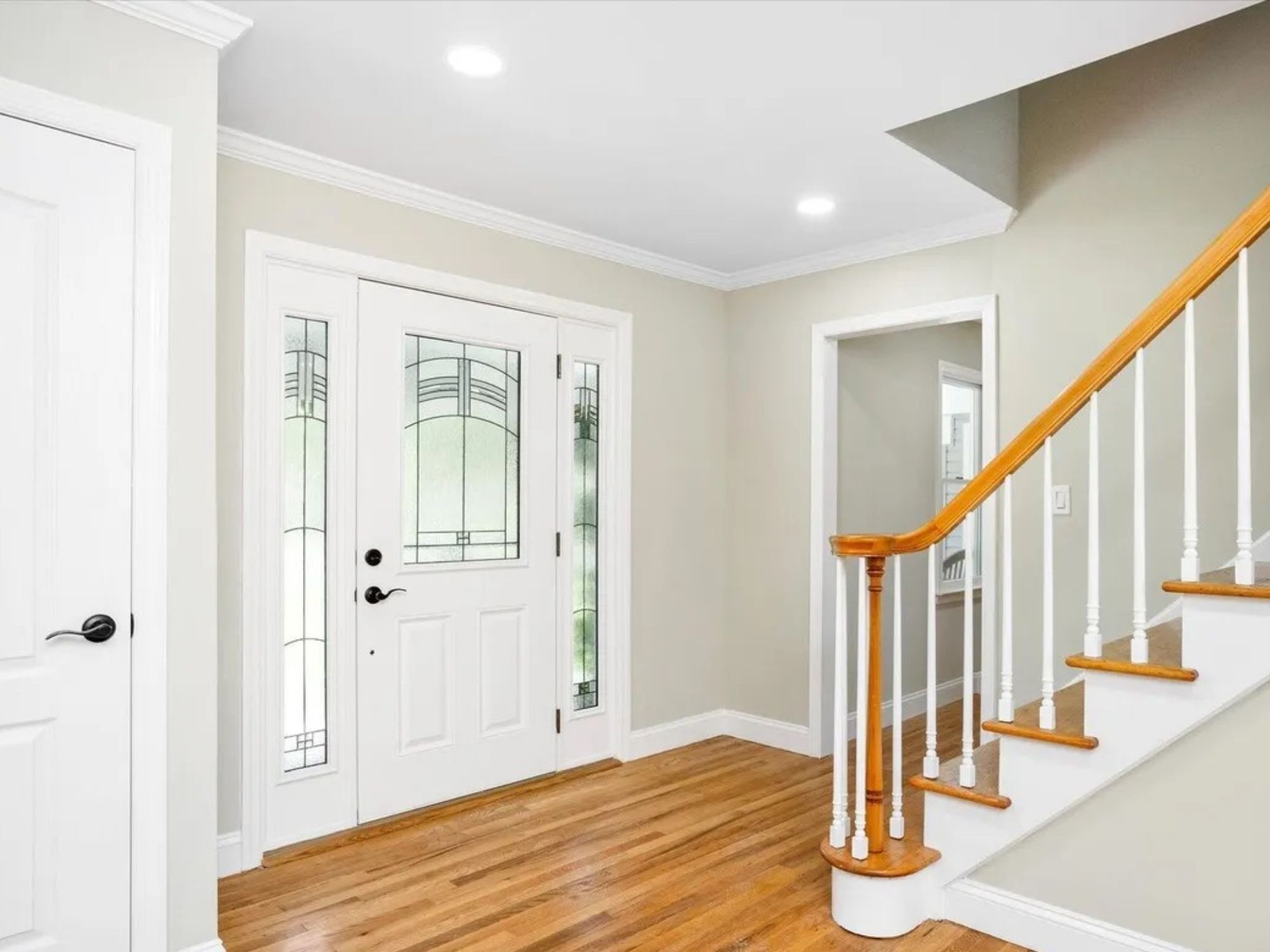 front entry foyer with wood staircase in a houghton contracting custom home project in trenton new jersey