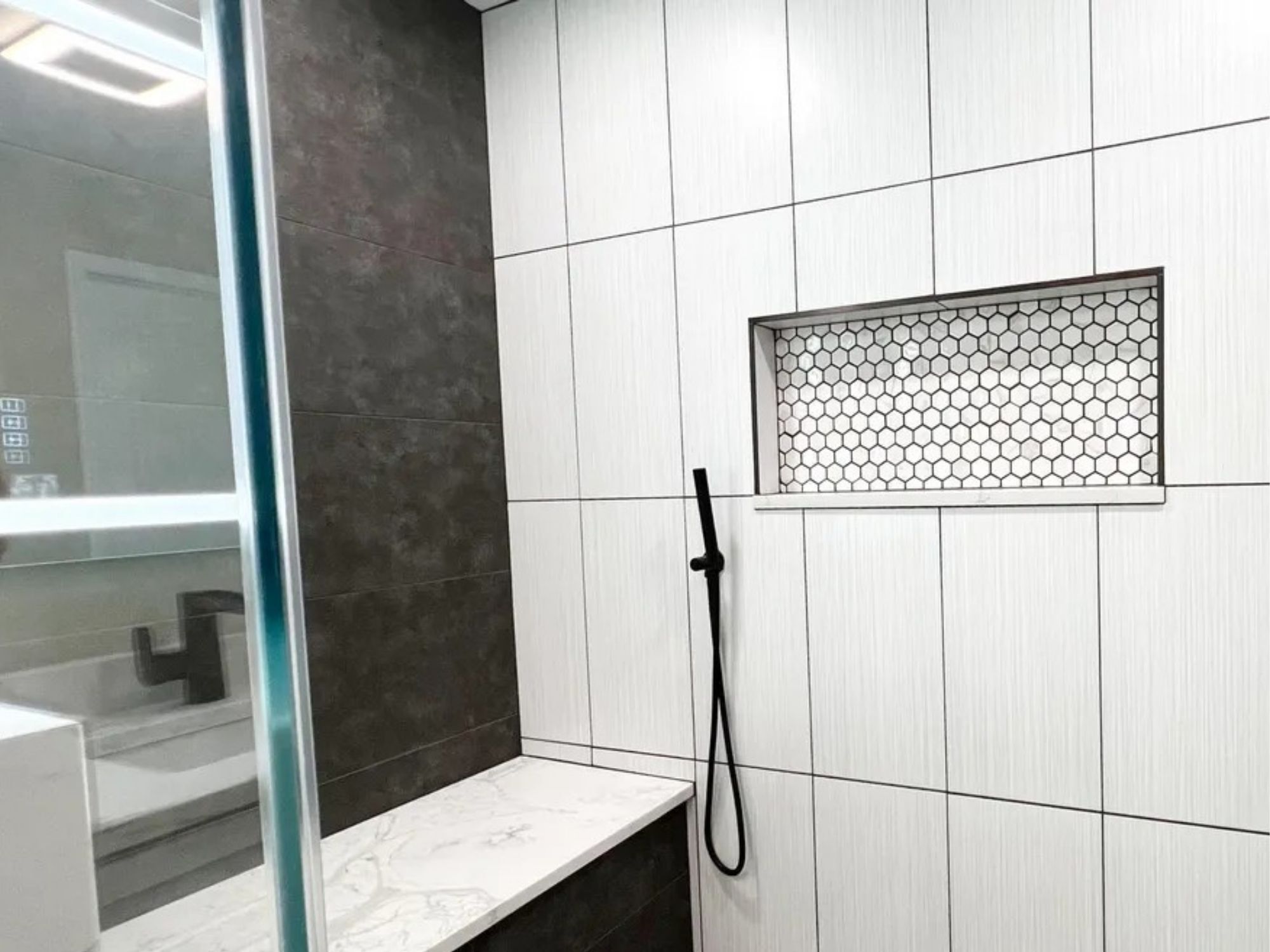 primary bathroom shower with hexagon tile niche in a houghton contracting custom home project in trenton new jersey