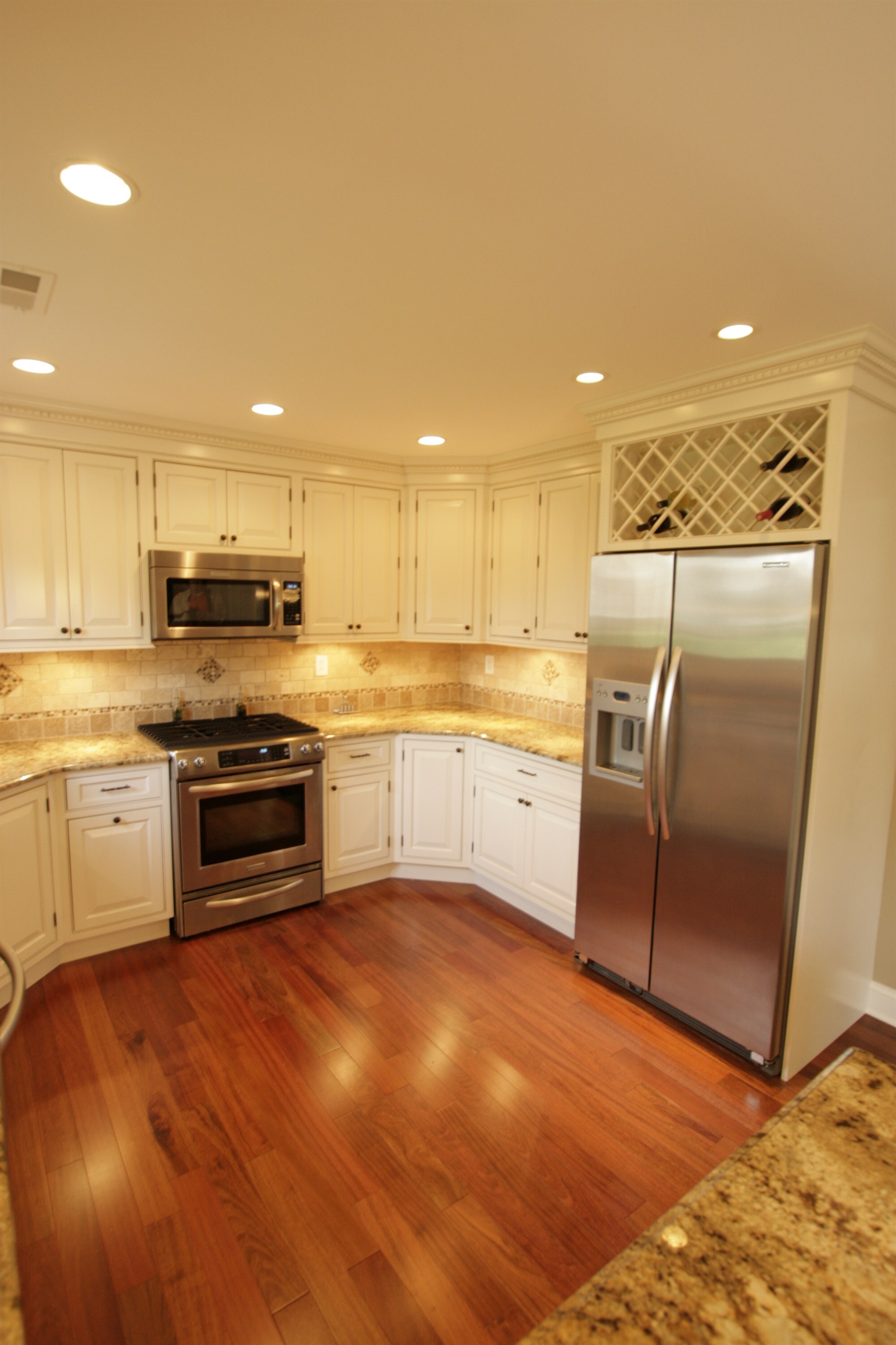 white kitchen with gas range refrigerator and hardwood floor houghton contracting custom home project in newtown pa-optimized
